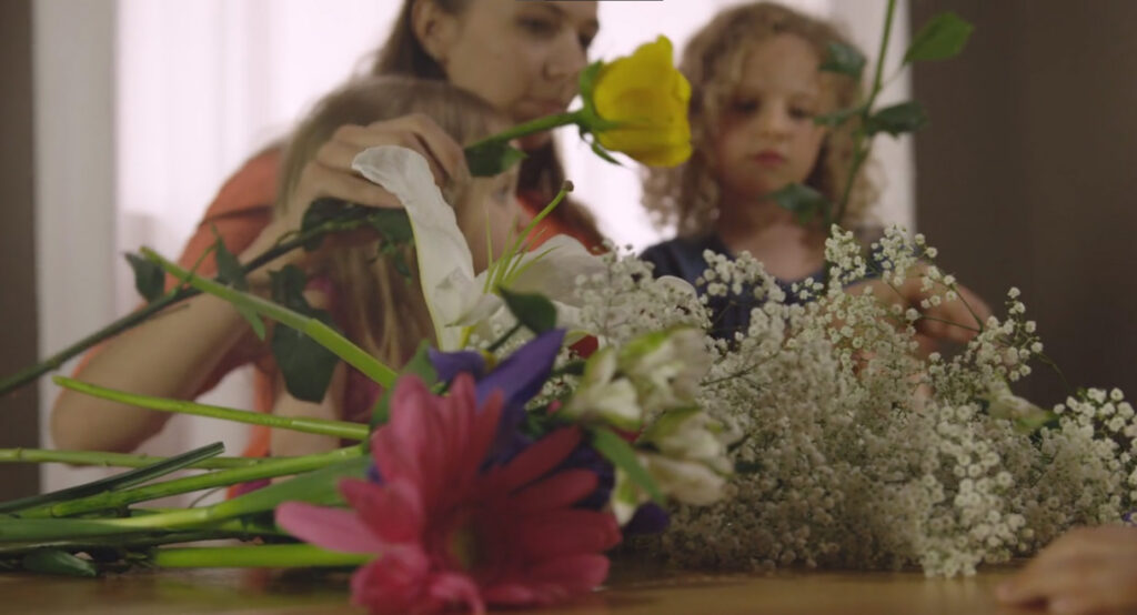 Still from documentary featuring family arranging flowers